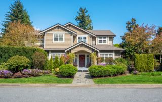 Roofing Sites in College Station, TX - Image of a luxury house with nicely trimmed front yard lawn in a residential area